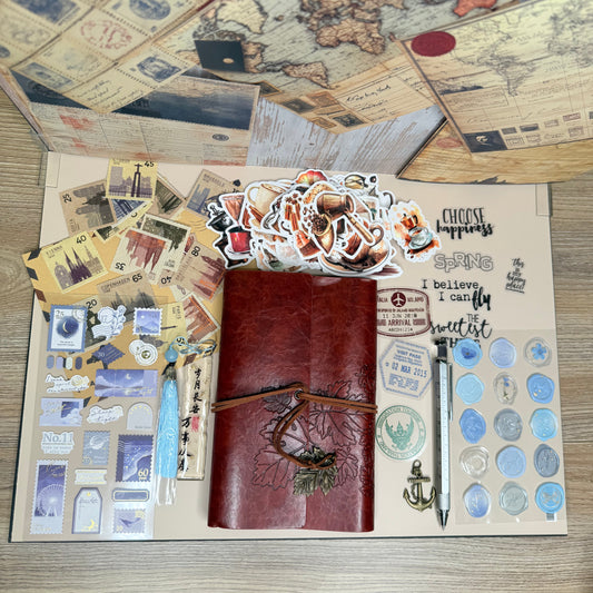 Collection of vintage-style items including a map, leather-bound books, and decorative stickers on a wooden surface.