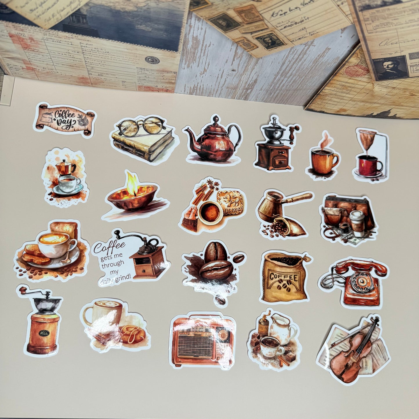 Collection of vintage-style stickers on a textured surface with old books and papers.