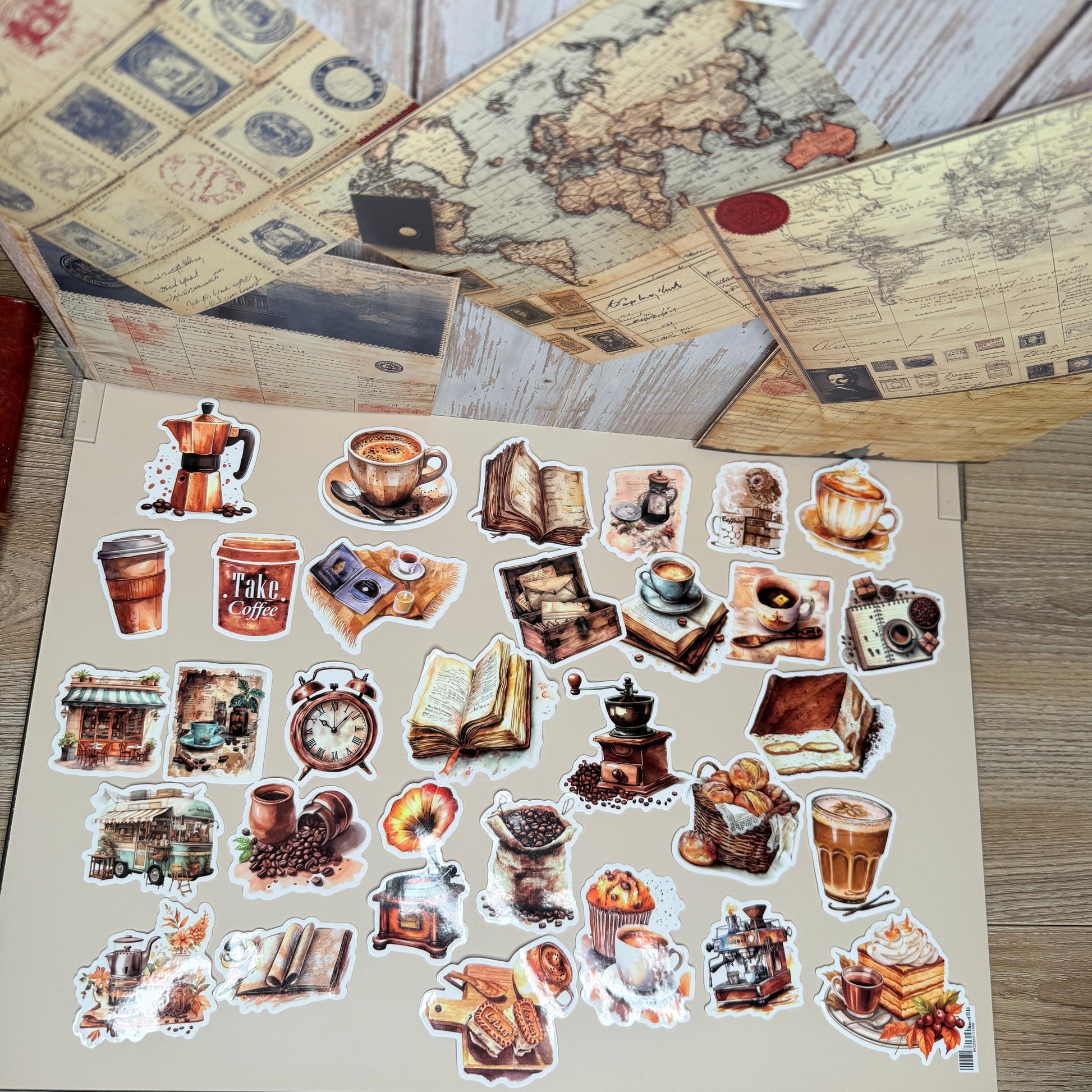 Sheet of vintage-style stickers with images of buildings and landscapes on a wooden surface.