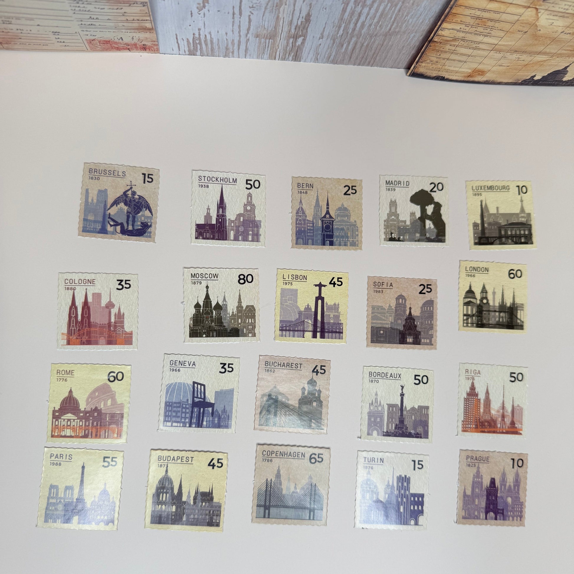 Collection of vintage stamps with architectural designs on a light surface.