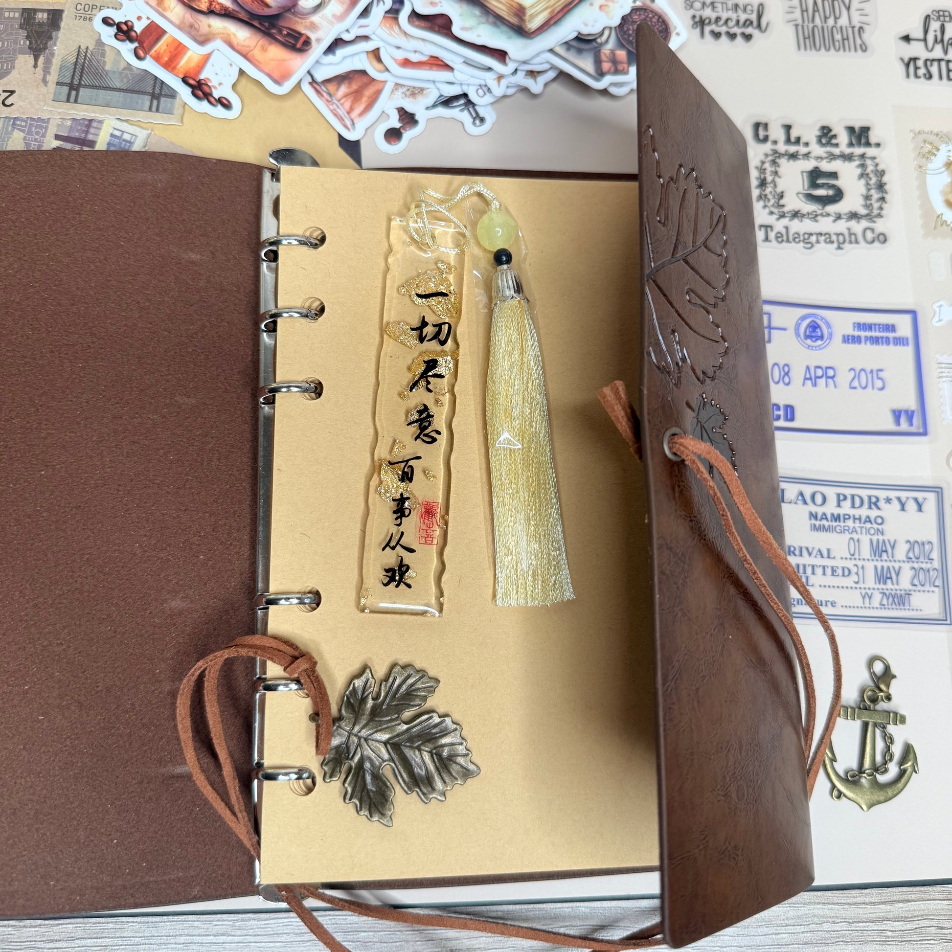 Brown leather-bound notebook with decorative elements on a textured surface