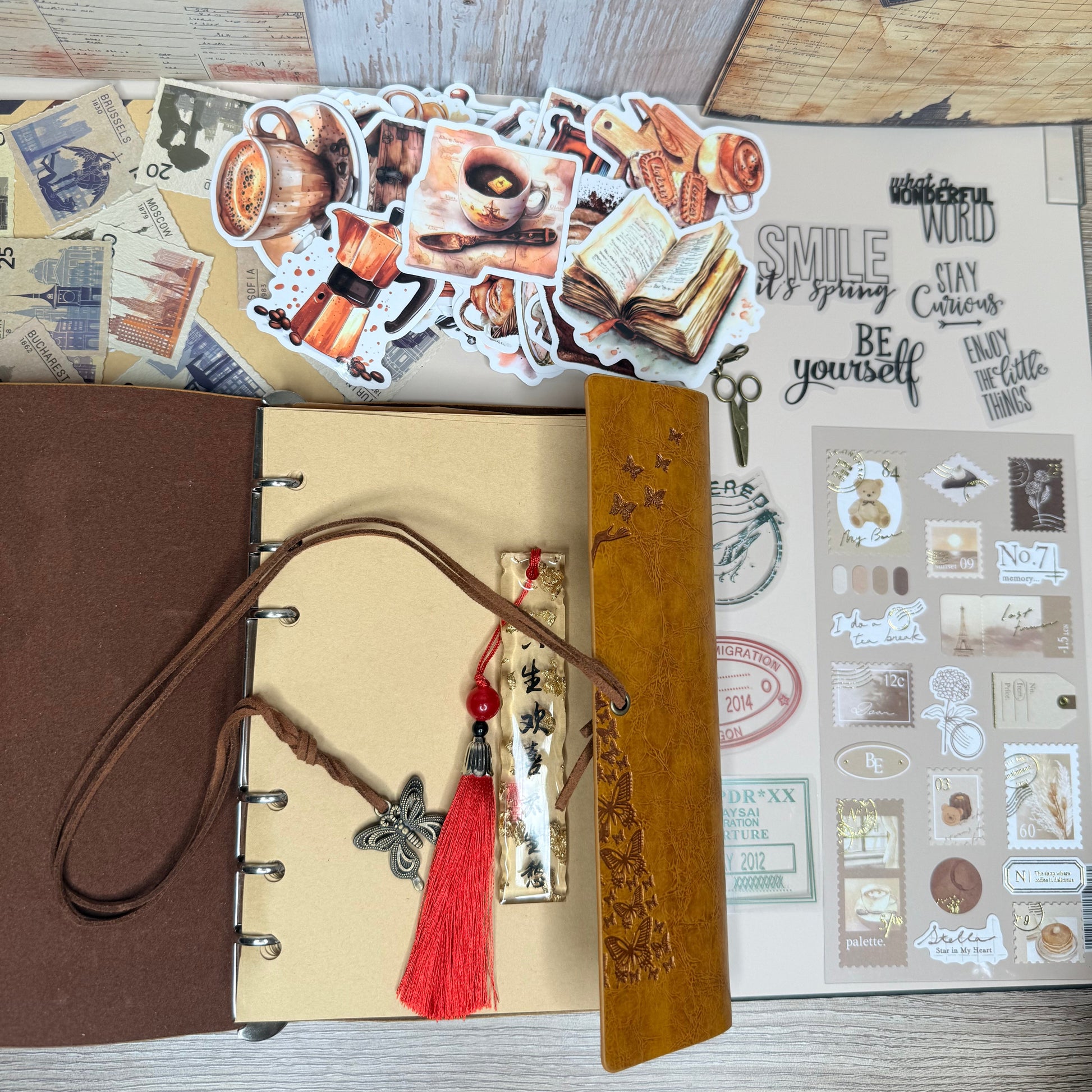 Open notebook with decorative elements on a wooden surface