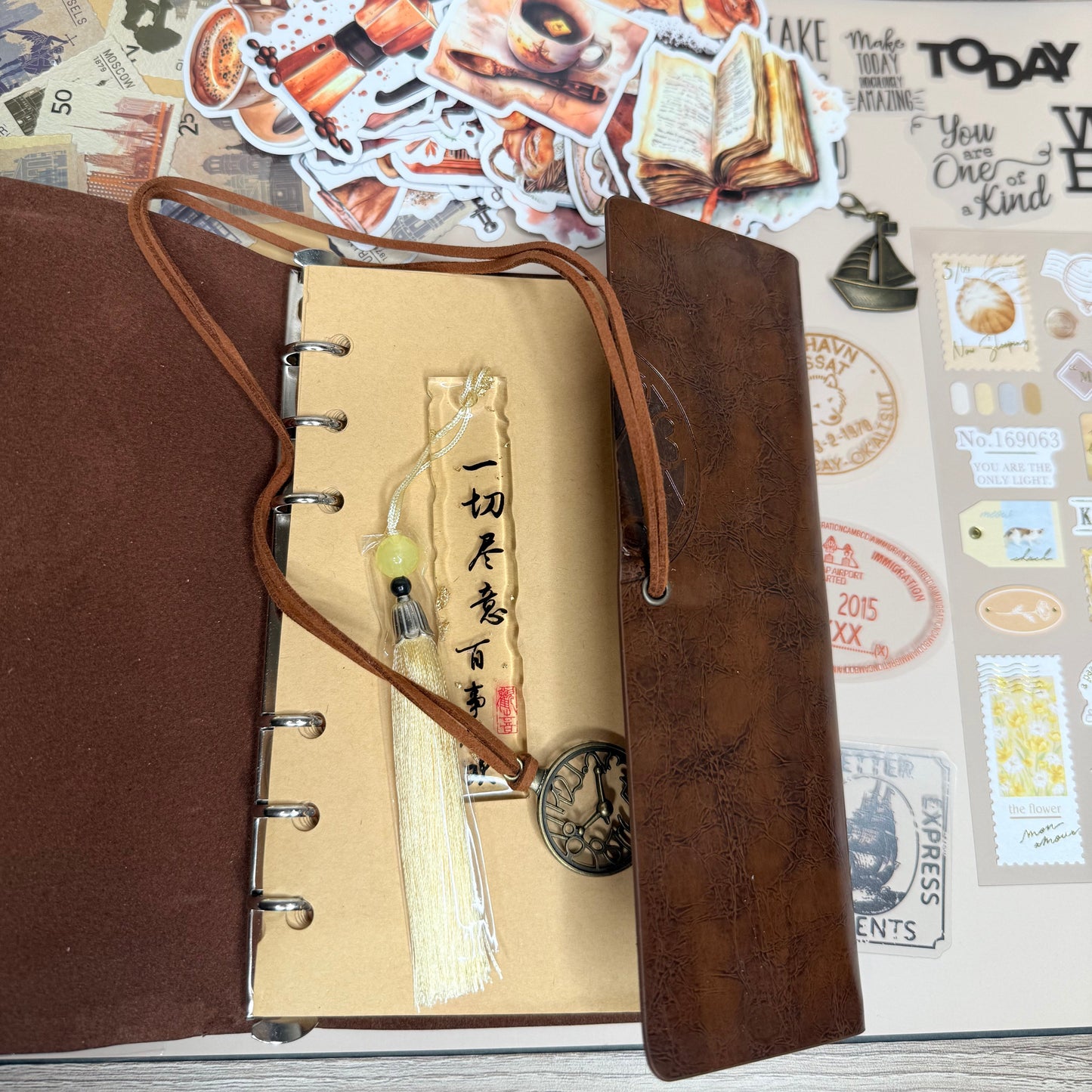 Brown leather-bound notebook with decorative elements on a textured surface