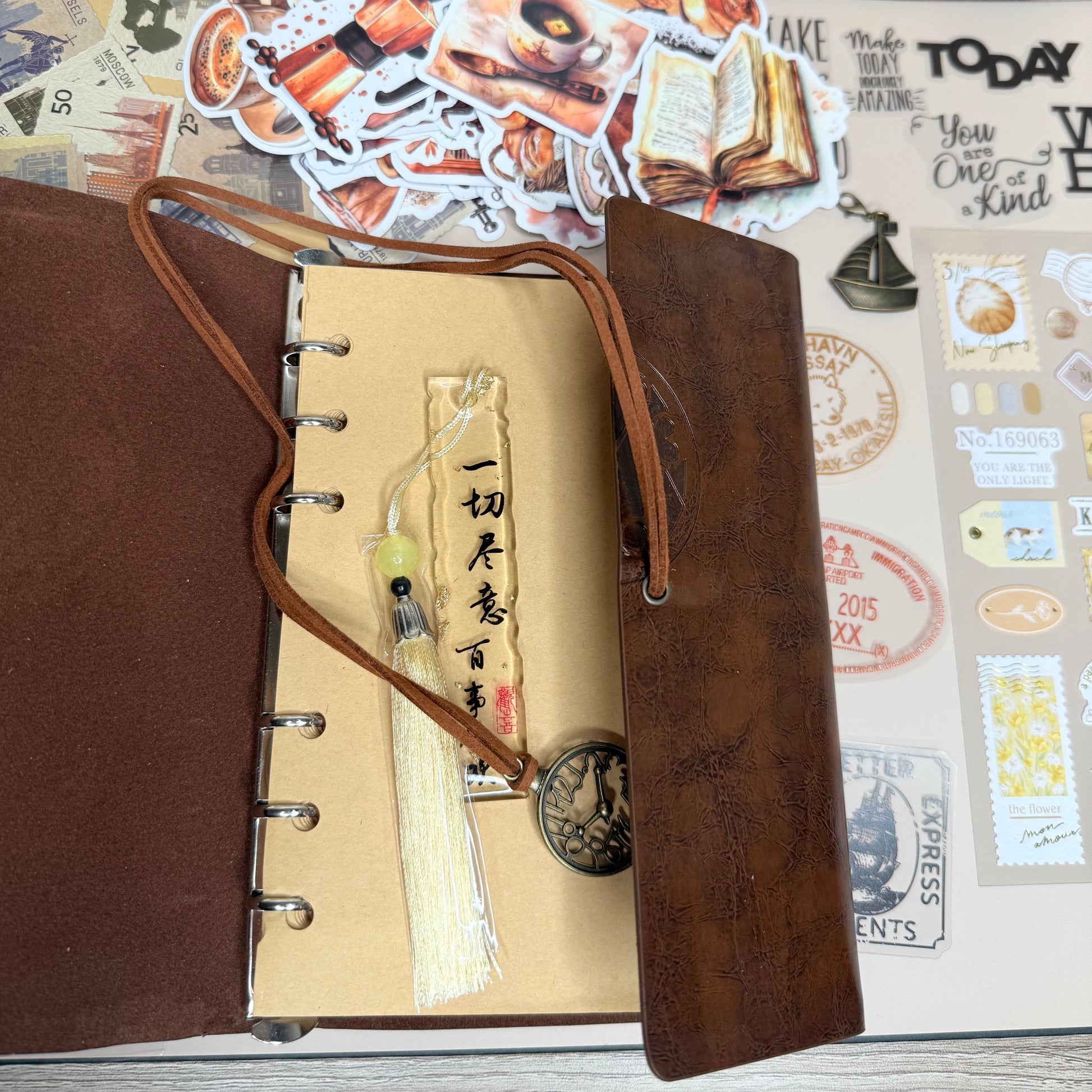 Brown leather-bound notebook with decorative elements on a textured surface