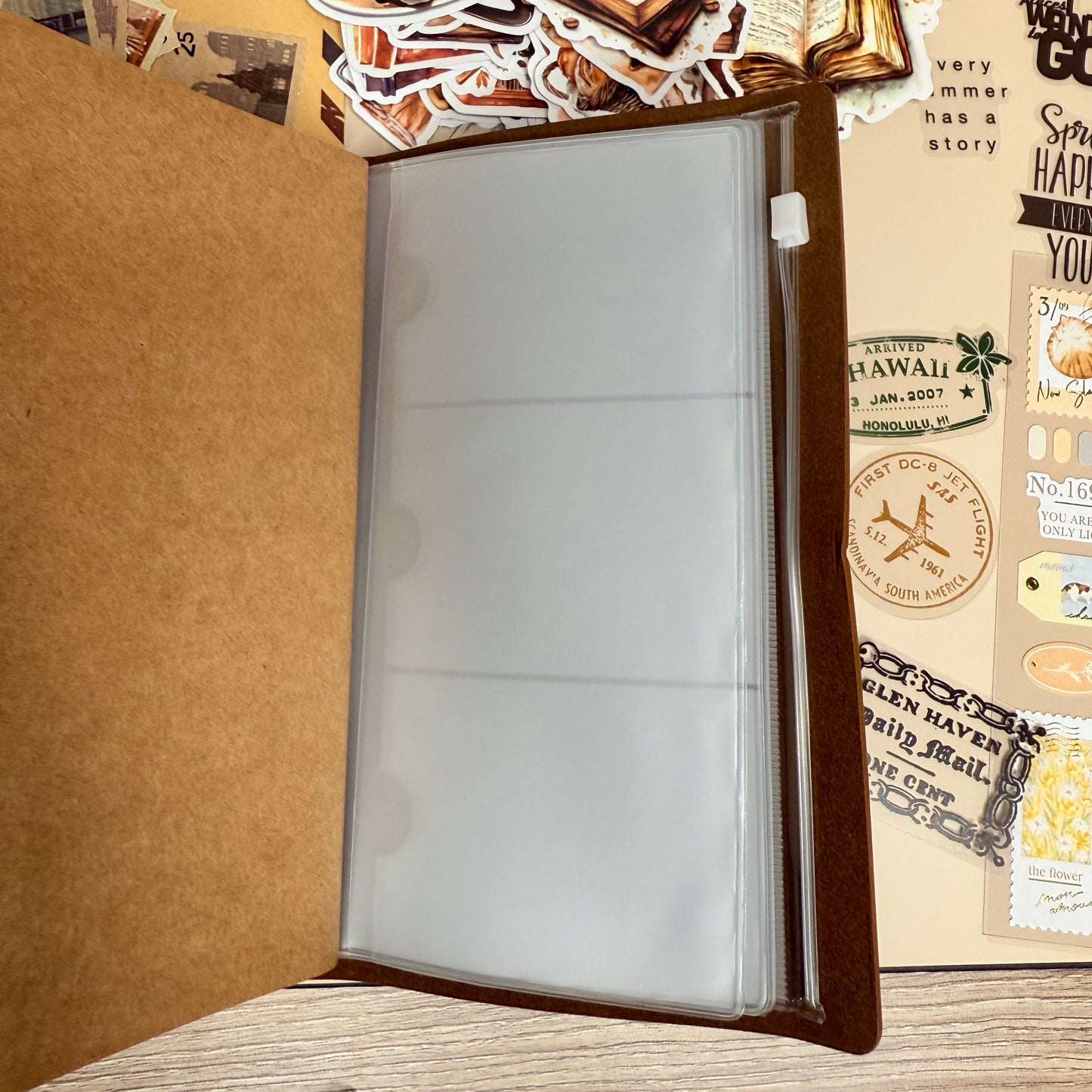Decorative mouse pad with travel-themed stickers on a wooden surface