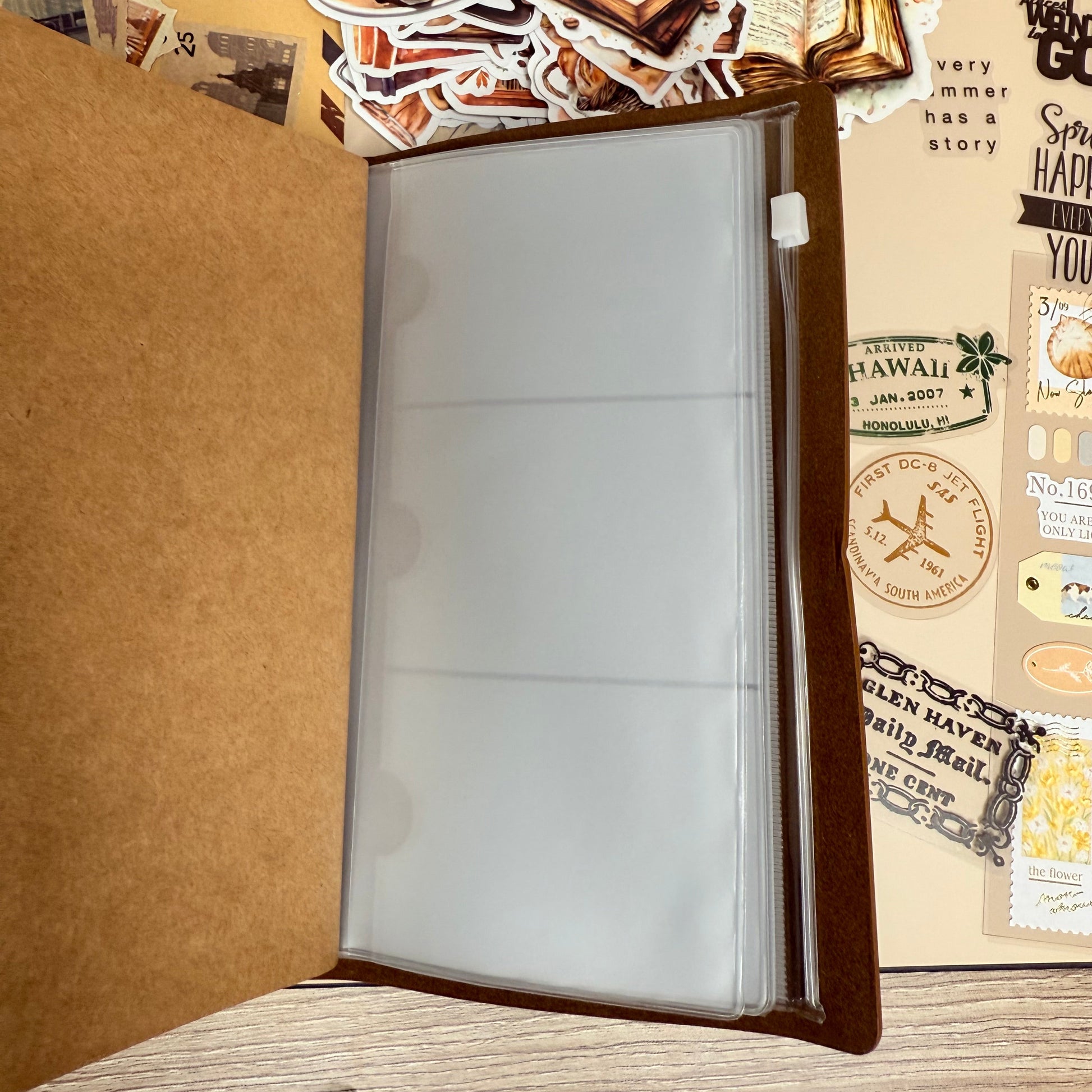 Decorative mouse pad with travel-themed stickers on a wooden surface