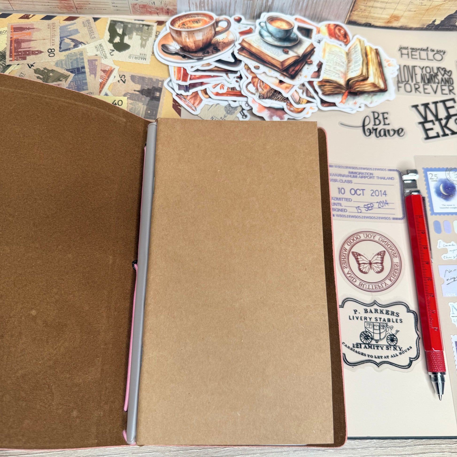 Brown notebook with stickers and a pen on a textured surface