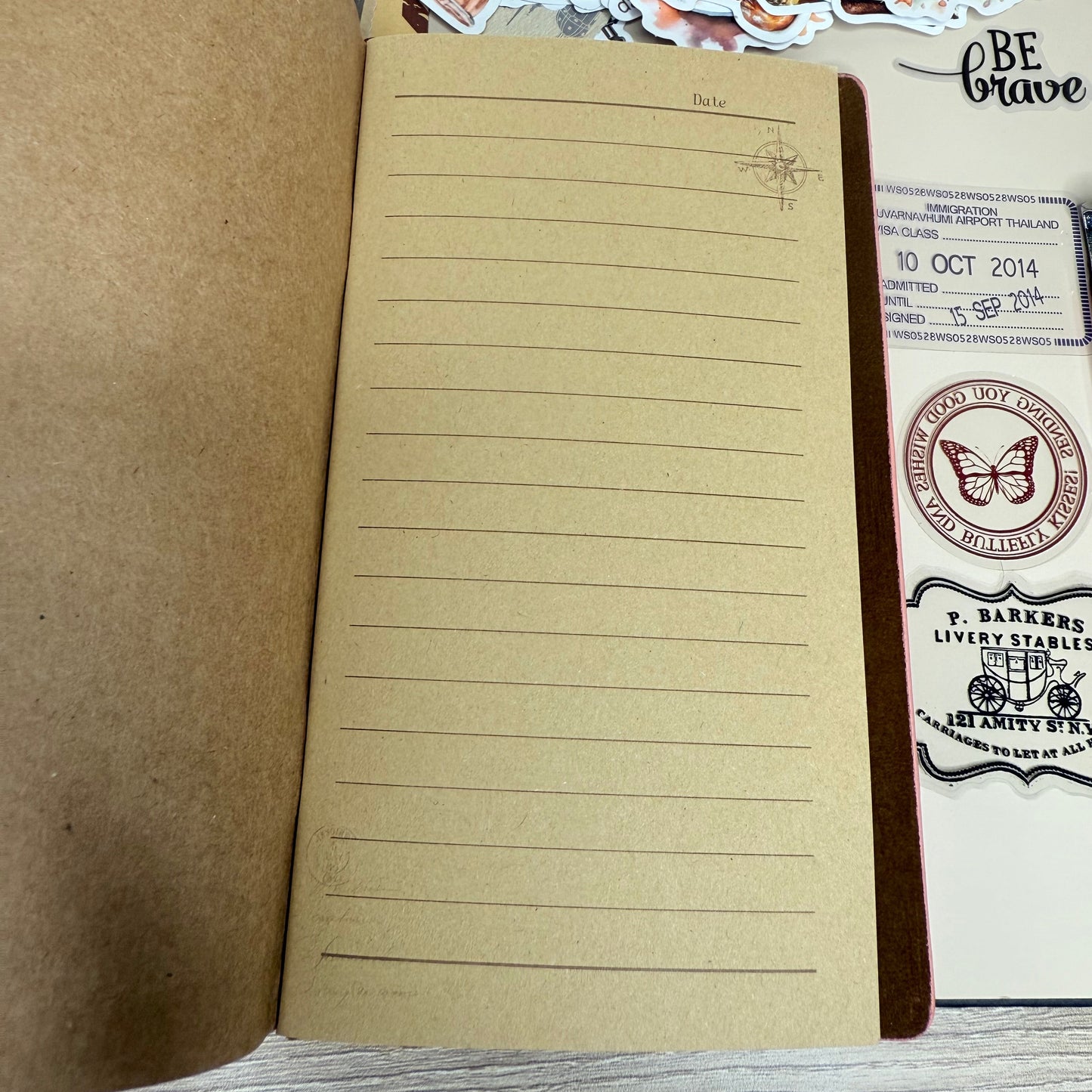 Notebook with lined pages and decorative stickers on a wooden surface