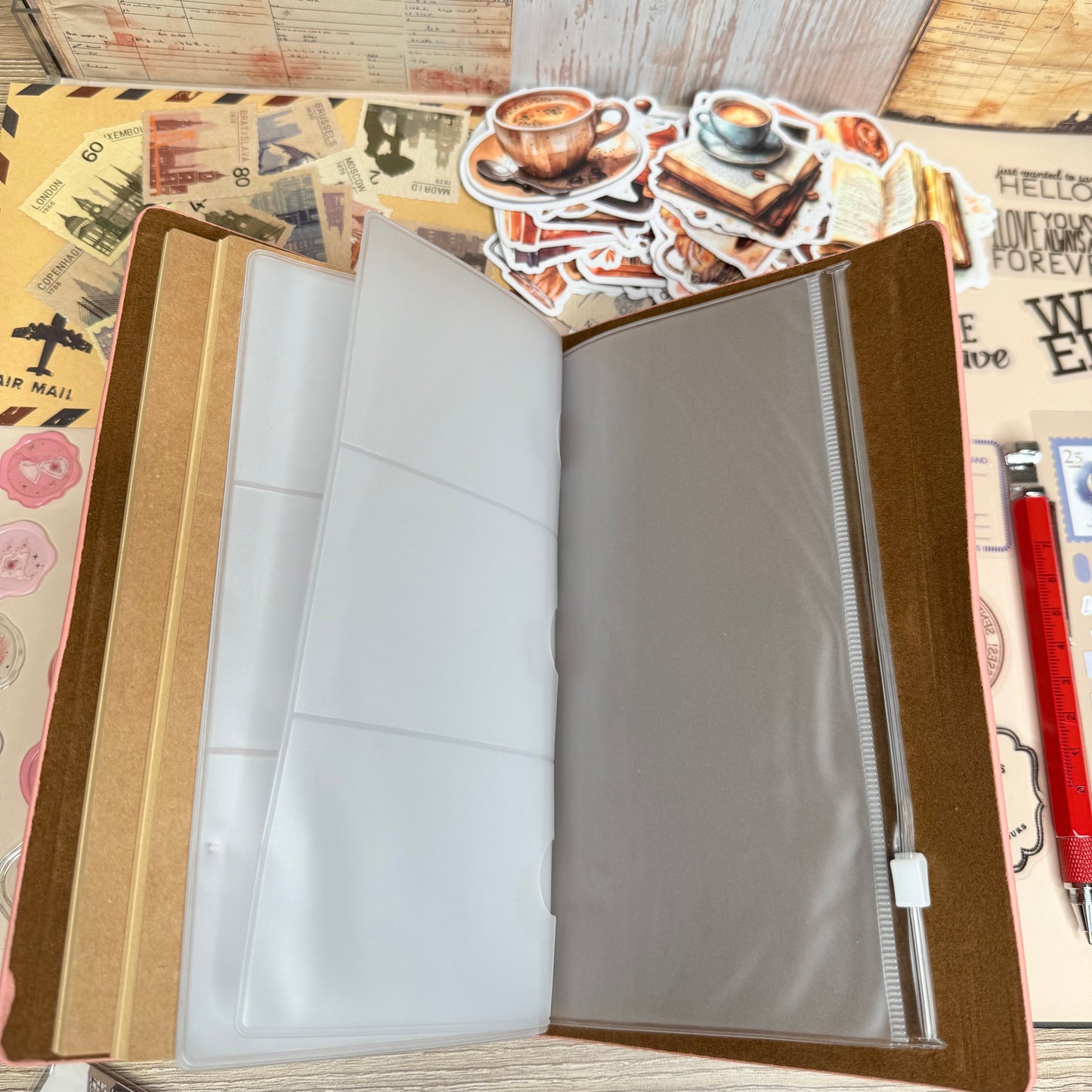 Open photo album with blank pages on a wooden surface with vintage-style paper.