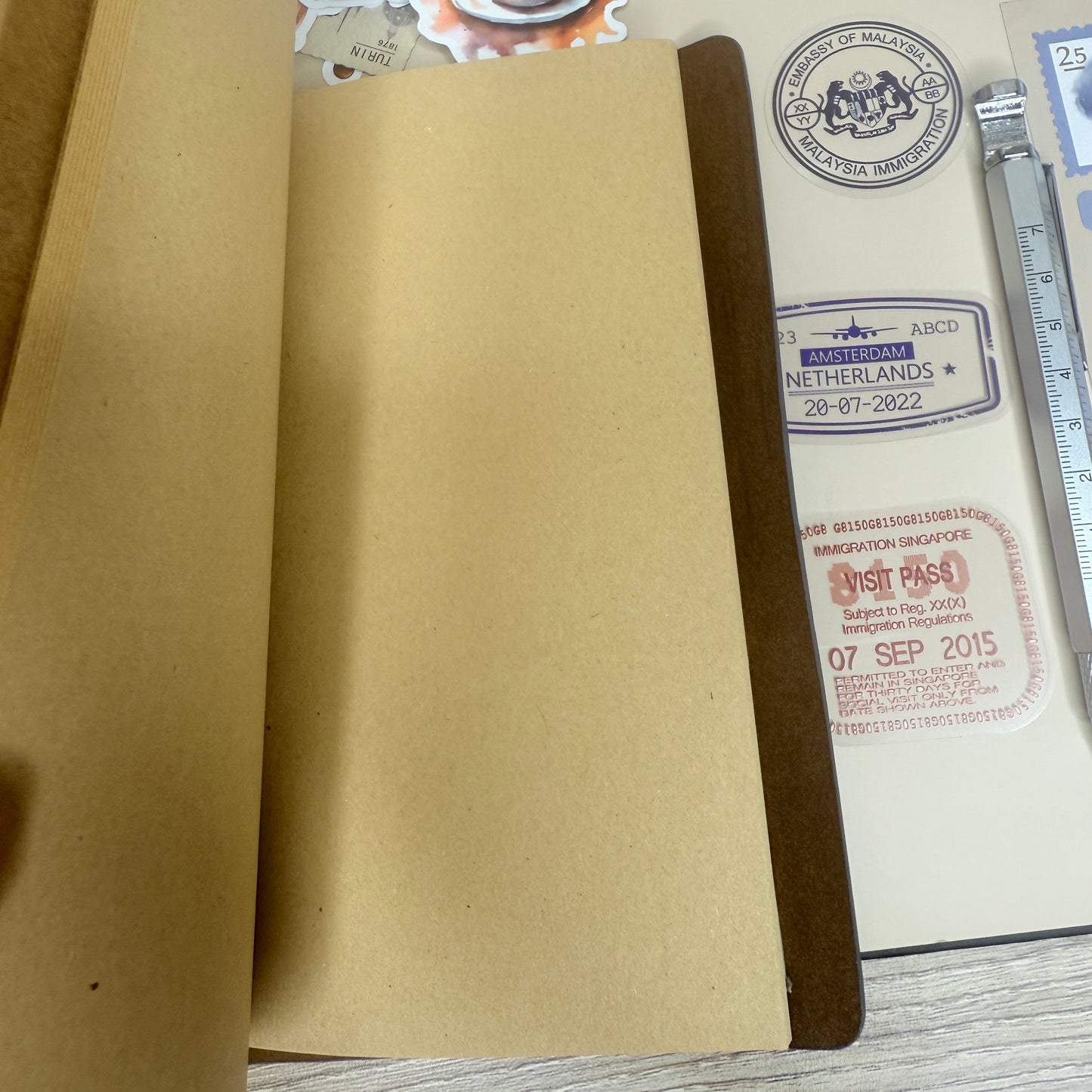 Brown envelope with stamps and a ruler on a wooden surface