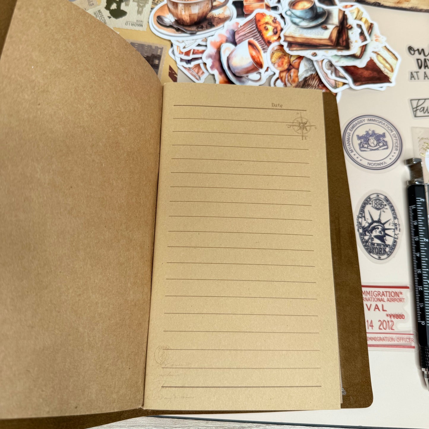 Notebook with lined pages and decorative stickers on a wooden surface