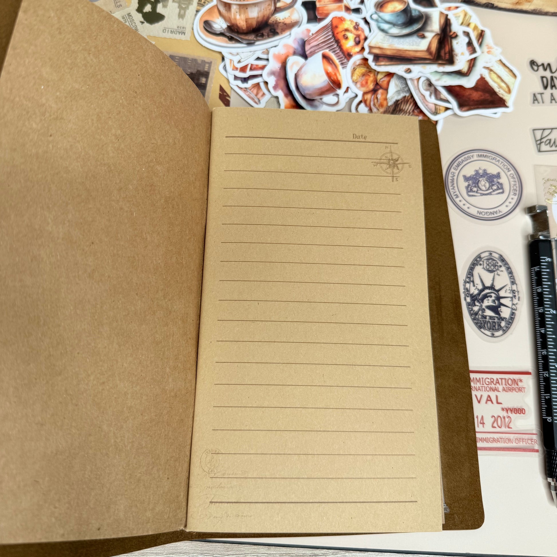 Notebook with lined pages and decorative stickers on a wooden surface