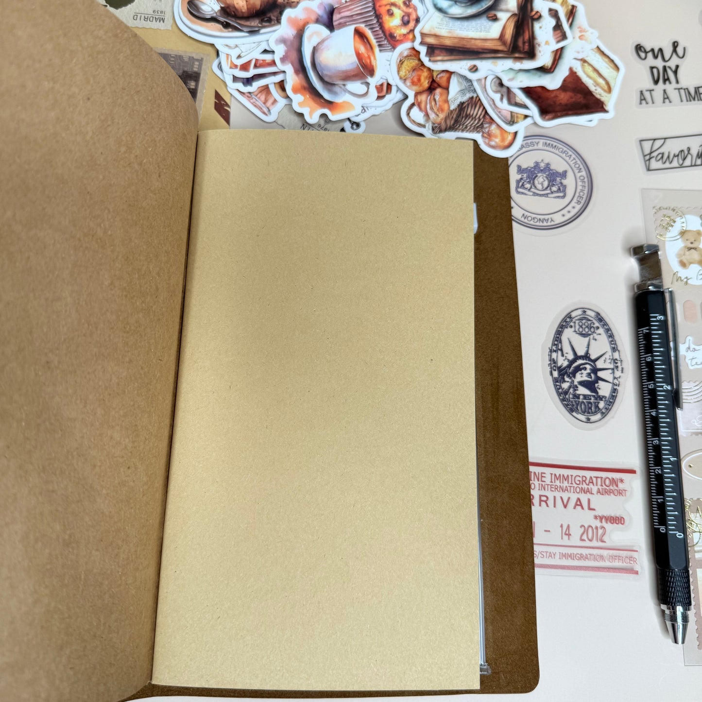 Open notebook with stickers on a wooden surface