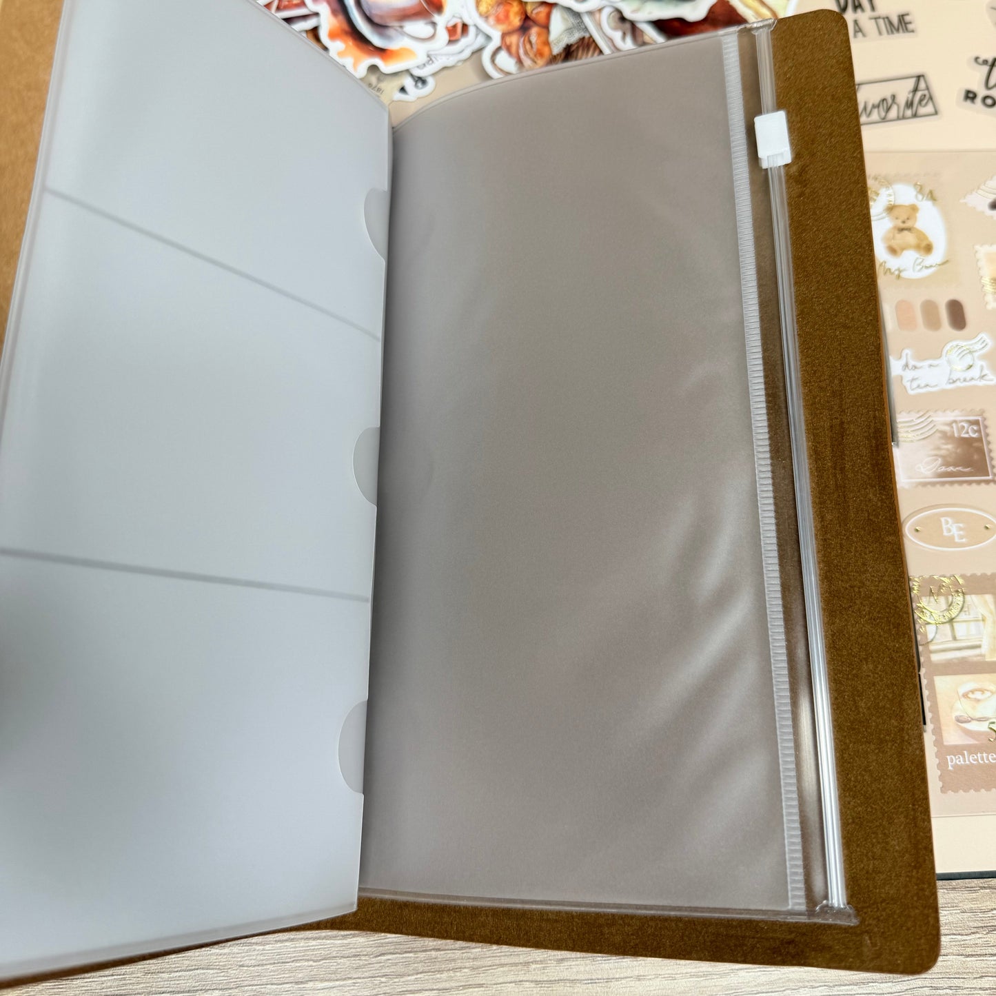 Album with photo stickers on a wooden surface