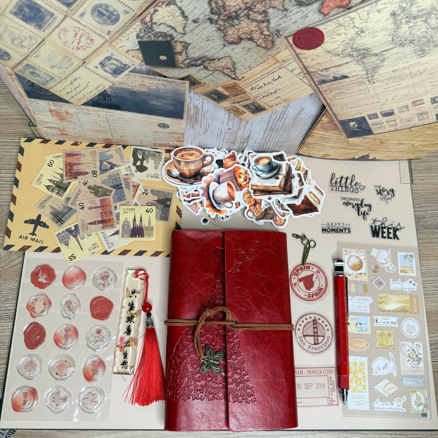 Collection of vintage-style stationery items on a wooden surface