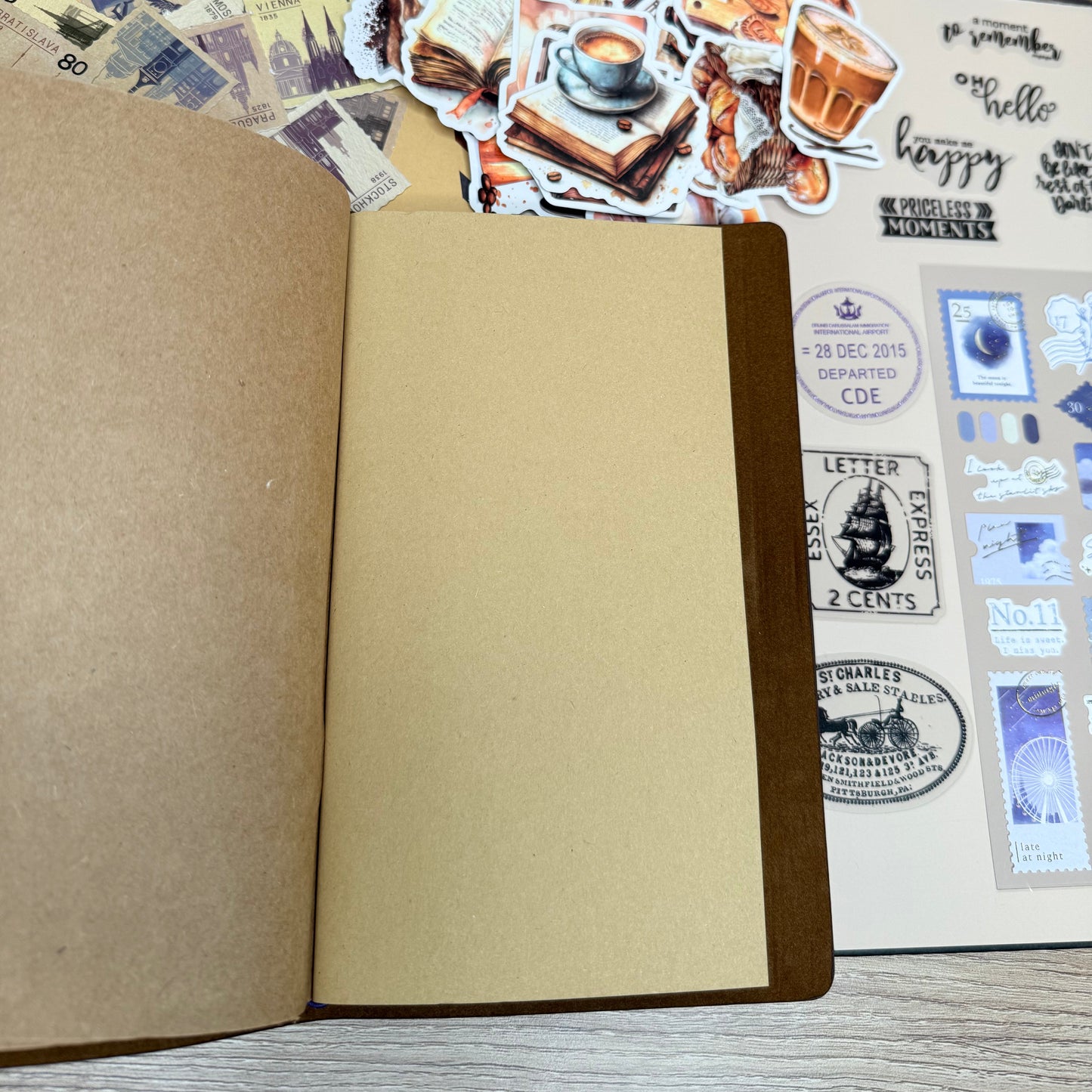 Open notebook with stickers and stamps on a wooden surface
