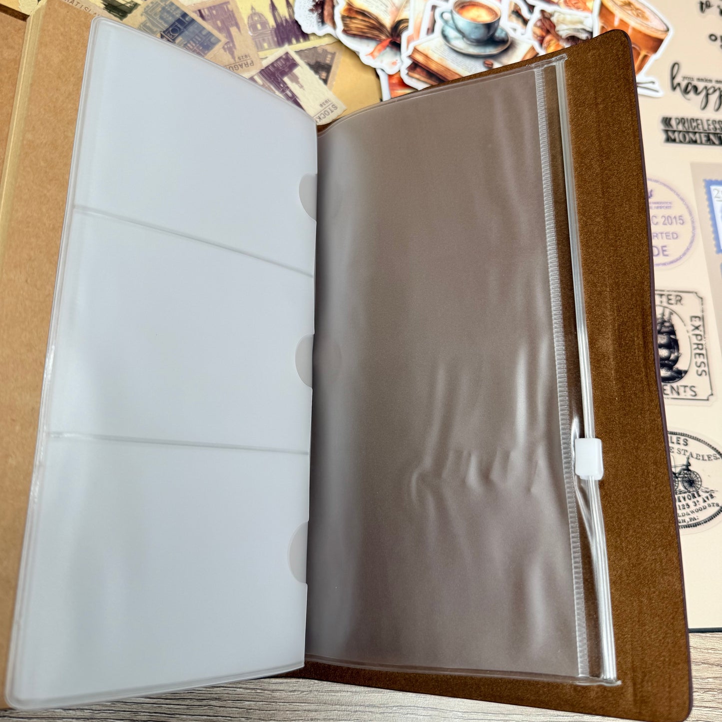 Open leather-bound album with a wooden frame on a textured surface