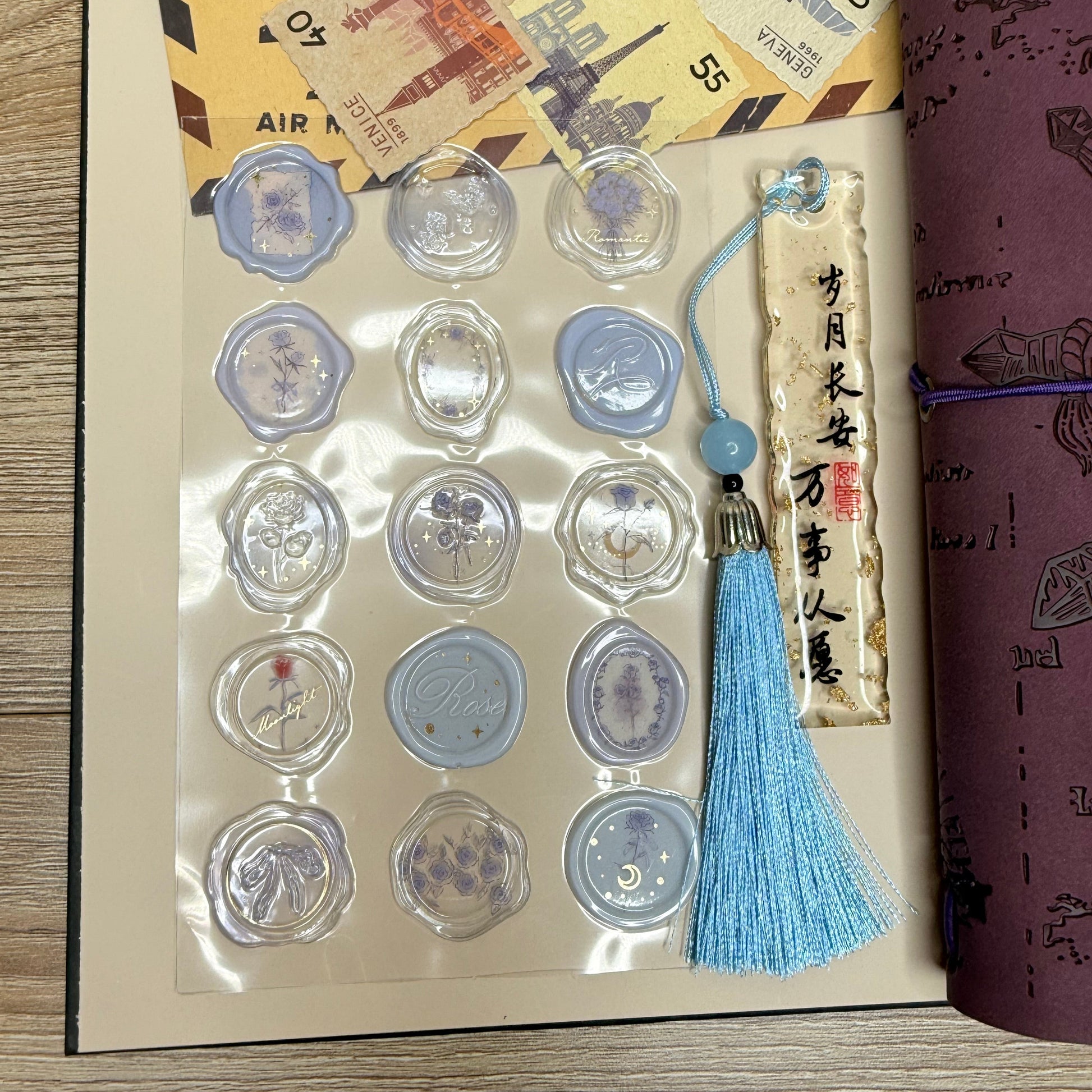 Collection of coins in display cases with a tassel and paper scroll on a wooden surface