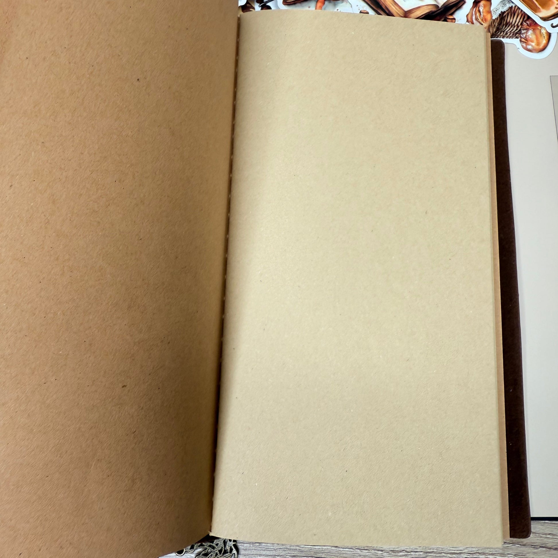 Unrolled brown paper on a wooden surface with a decorative border.