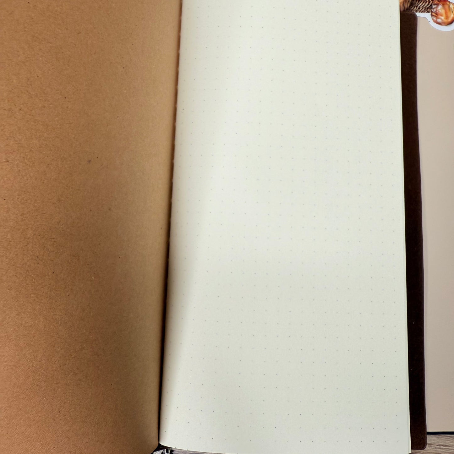 Roll of white paper on a brown surface with a patterned border