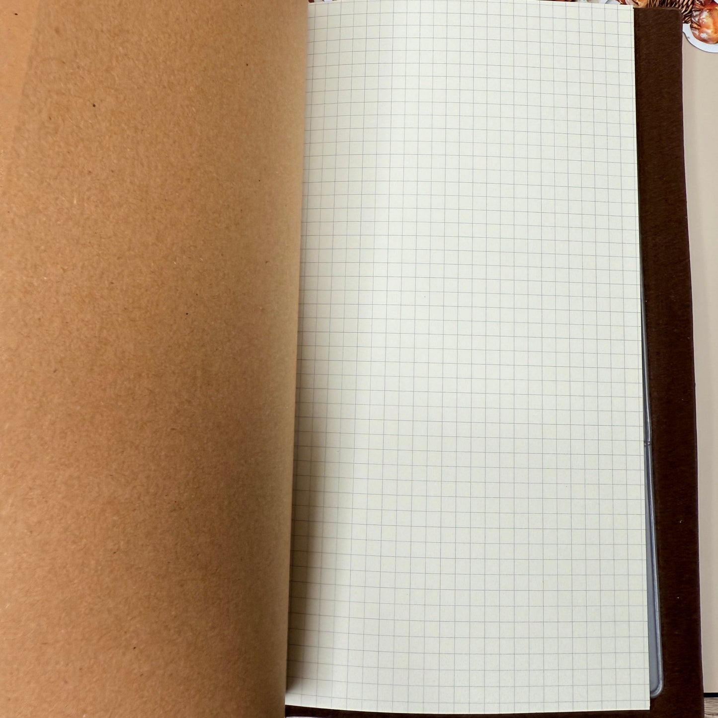 Roll of brown paper with a grid pattern on a cardboard box