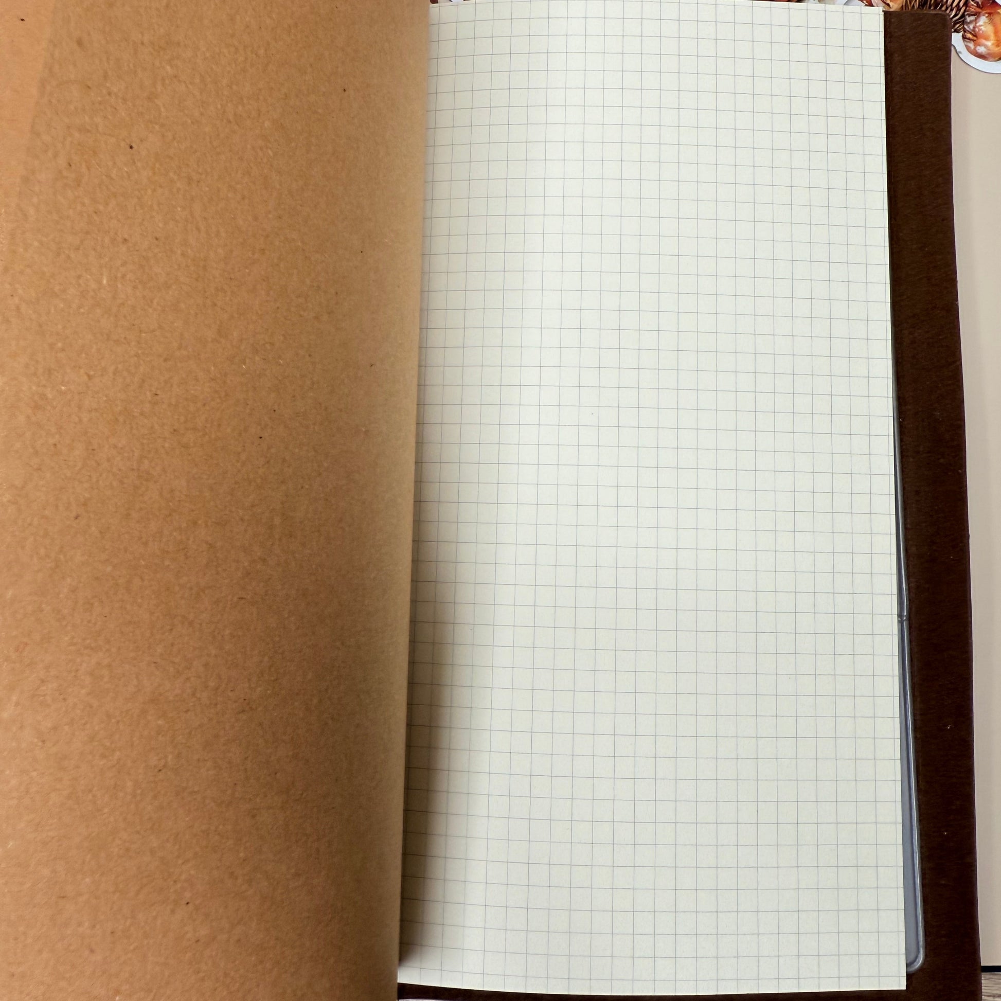 Roll of brown paper with a grid pattern on a cardboard box
