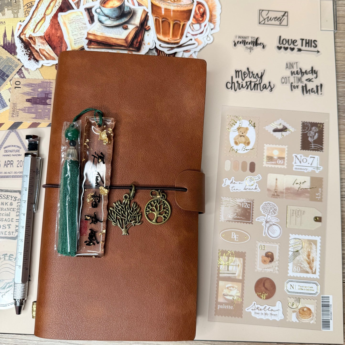 Brown leather notebook with decorative elements on a wooden surface