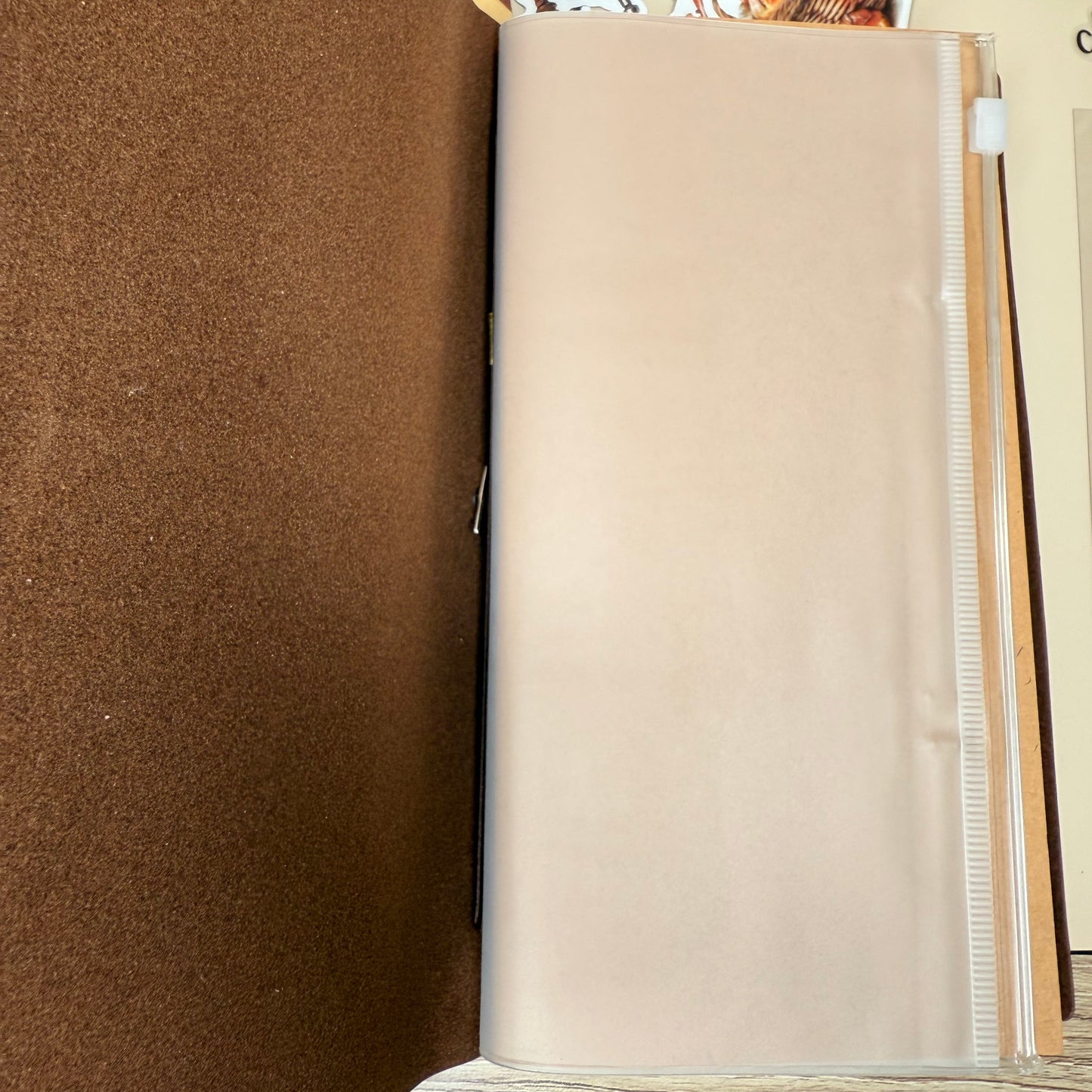 Brown fabric on a table with a beige roll of paper towels in the background.