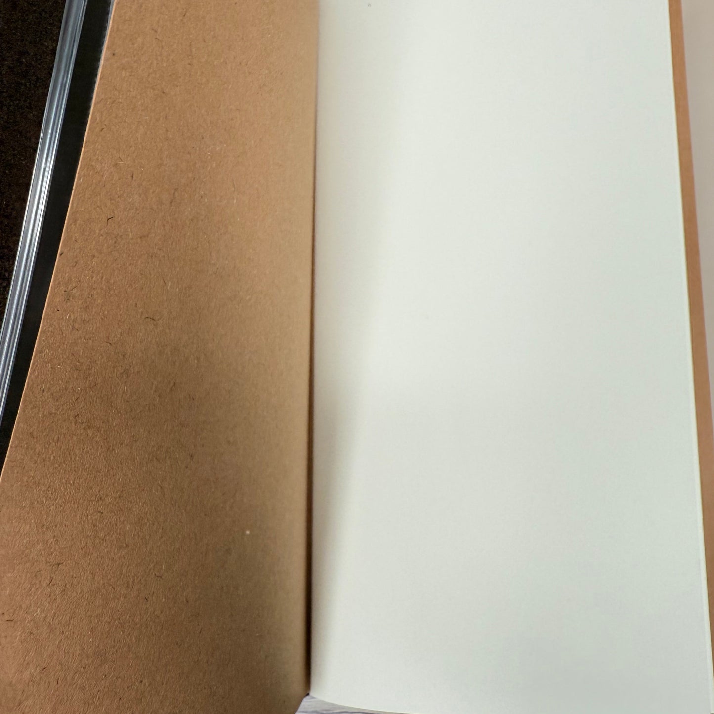 Close-up of a cardboard box with a white sheet of paper on top