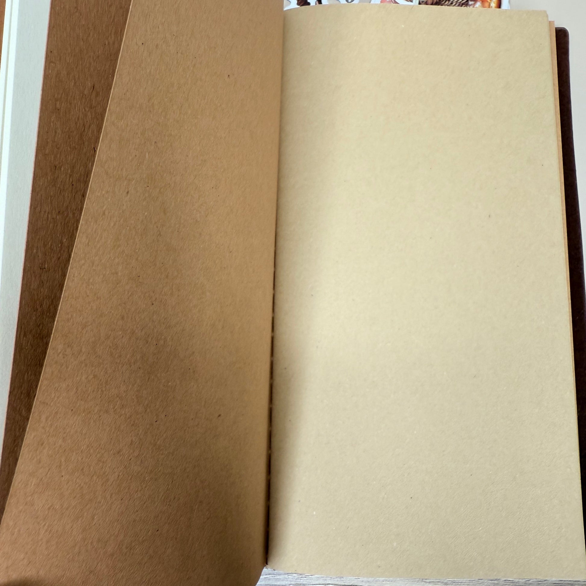 Brown paper bag with a partially visible poster on a wooden surface