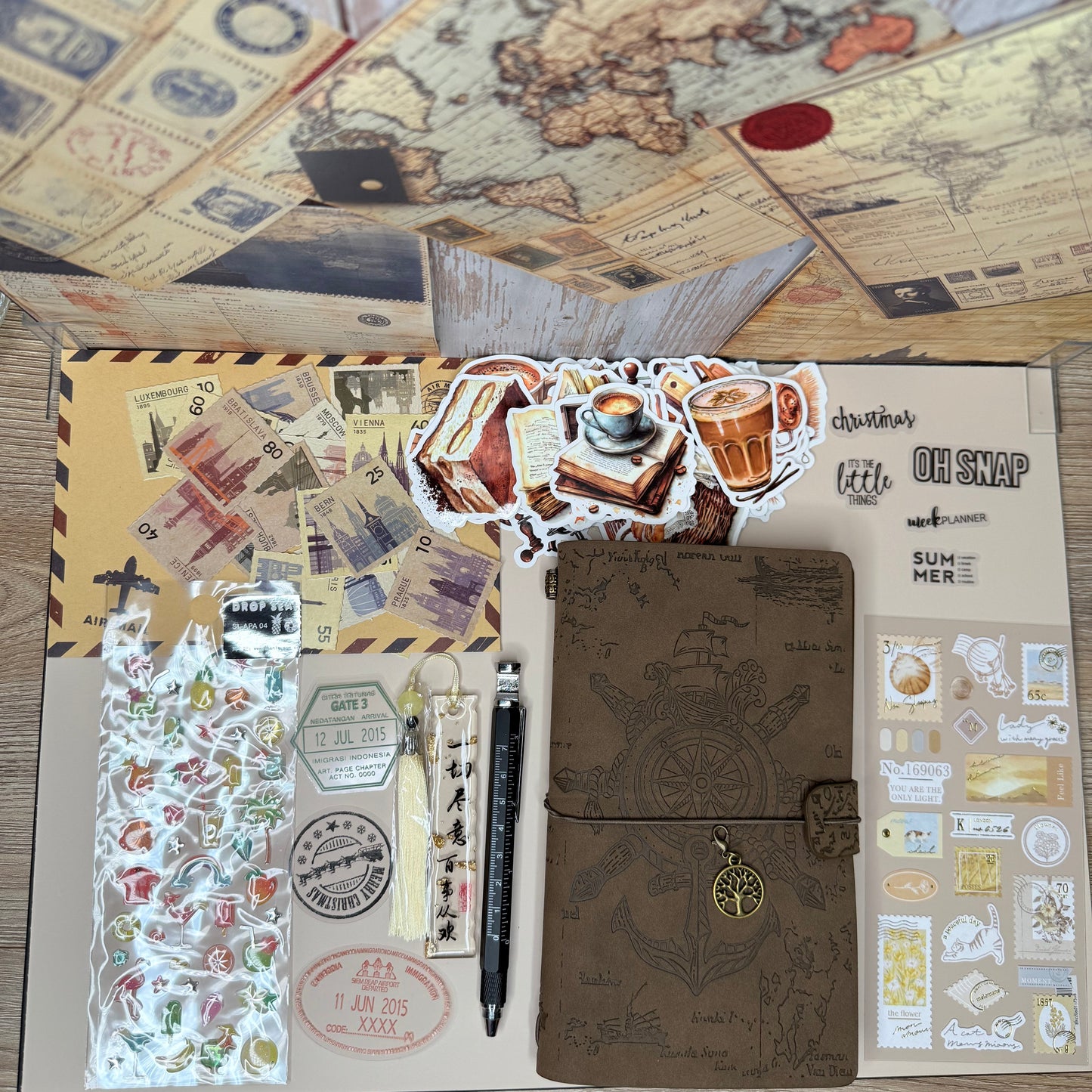 Stationery set with a notebook, stickers, and pen on a wooden surface