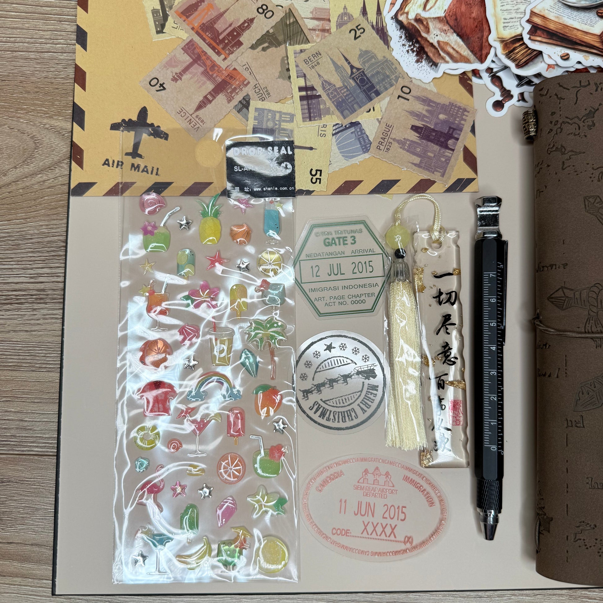 Collection of stationery items including stickers, a pen, and a stamp on a wooden surface.