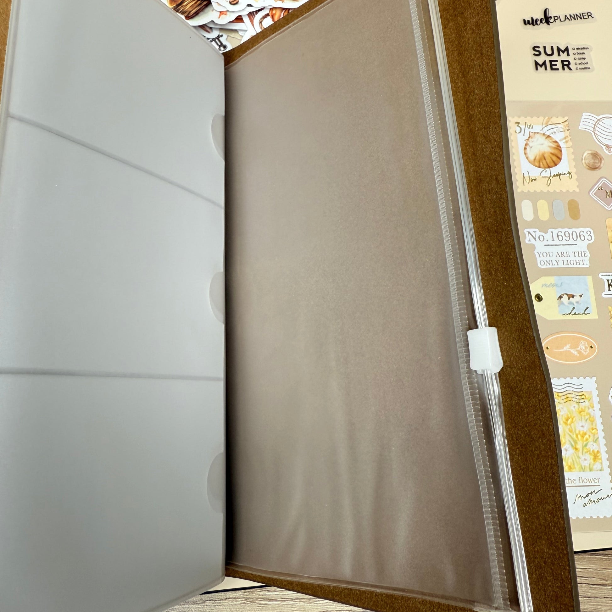 Open beige folder with a wooden frame on a textured wall background