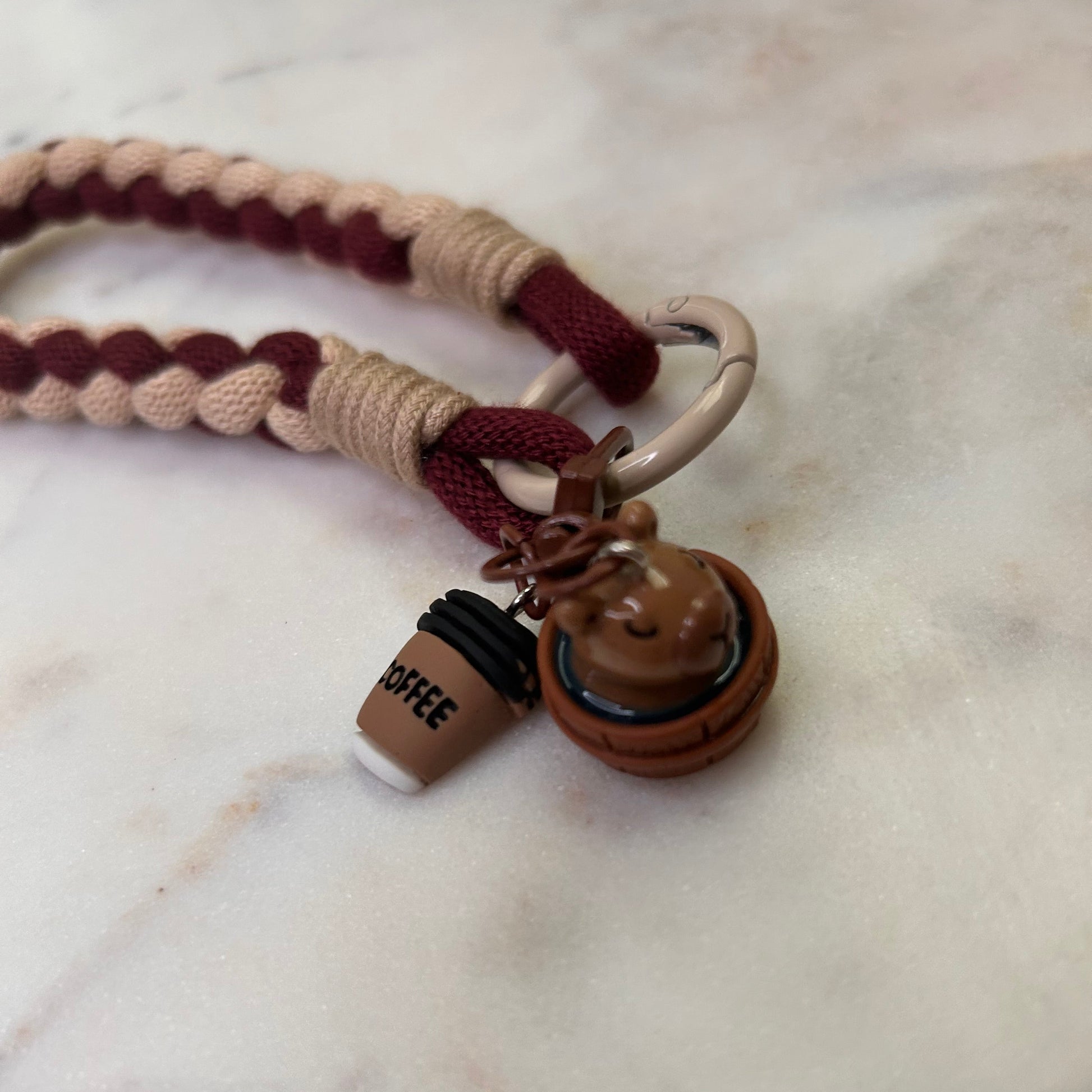 Leash with braided design and metal clasp on a marble surface
