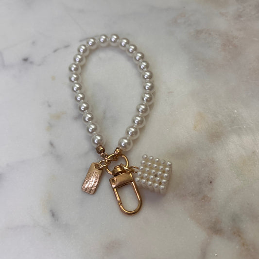 Pearl bracelet with gold clasp on a marble surface