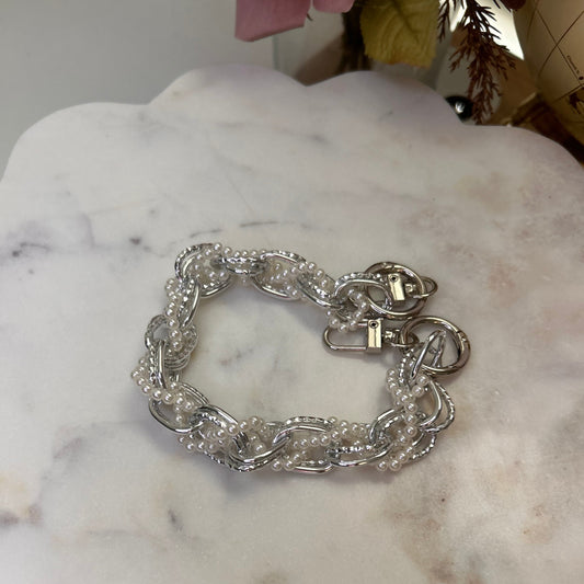 Silver chain bracelet on a marble surface